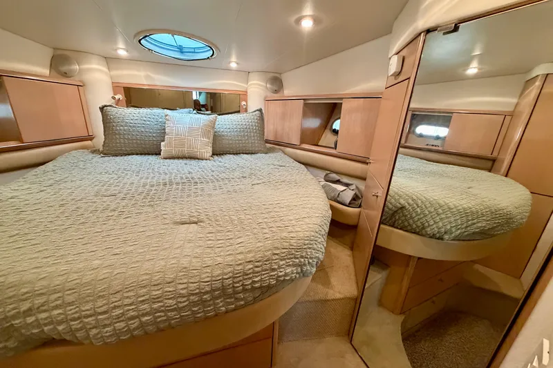 Slide: The Image of Cozy bedroom interior of 1997 Avanti 4085 Sunbridge yacht with plush bedding and mirrored closet. - 15