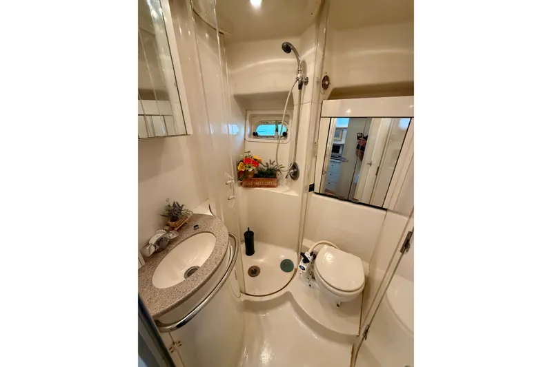 Slide: The Image of Bathroom interior of 1997 Avanti 4085 Sunbridge yacht, featuring sink, shower, and toilet. - 16