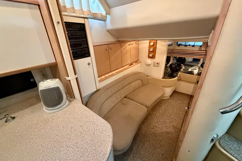 Slide: The Image of Interior of a 1997 Avanti 4085 Sunbridge yacht with beige seating and wood accents. - 18