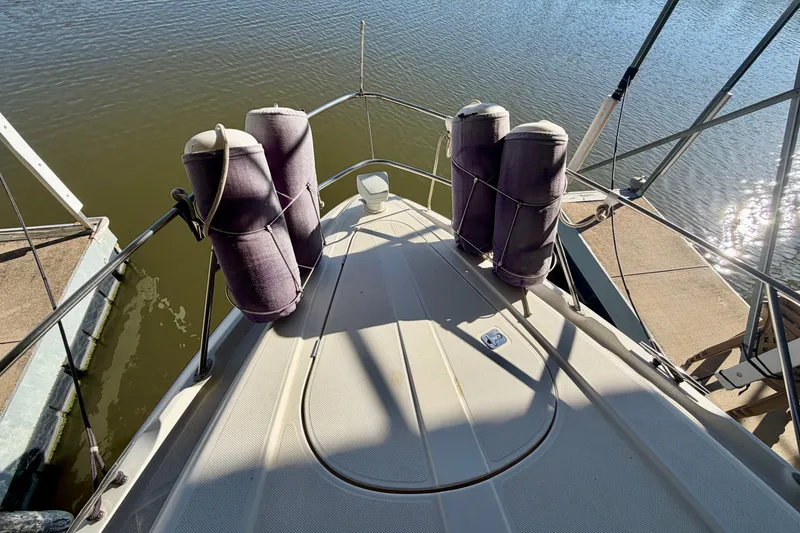 Slide: The Image of Bow view of 1997 Avanti 4085 Sunbridge yacht docked on calm water. - 22