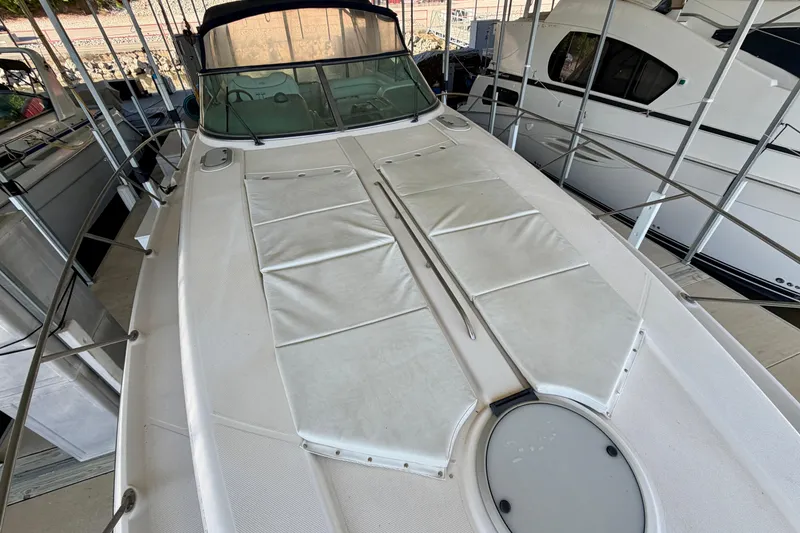 Slide: The Image of 1997 Avanti 4085 Sunbridge boat docked, featuring spacious deck and sleek design. - 24