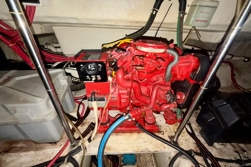 Slide: The Image of Engine compartment of a 1997 Avanti 4085 Sunbridge with red machinery and wiring. - 28