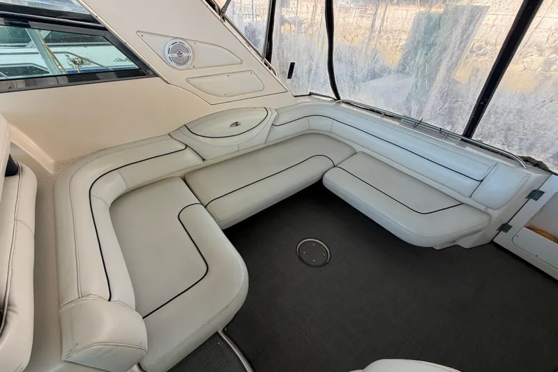 Slide: The Image of Luxurious interior seating of a 1997 Avanti 4085 Sunbridge yacht, featuring white leather upholstery. - 3