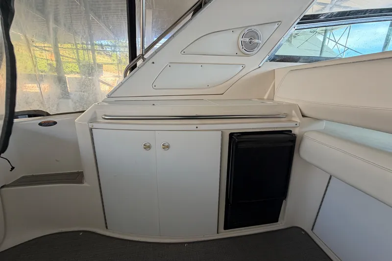 Slide: The Image of Interior of a 1997 Avanti 4085 Sunbridge yacht, featuring a compact kitchenette area. - 4