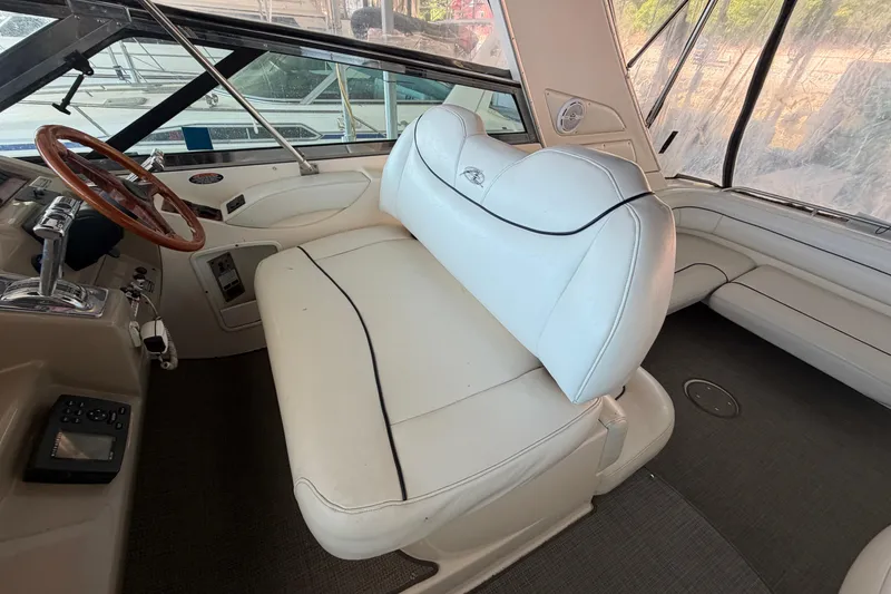 Slide: The Image of 1997 Avanti 4085 Sunbridge boat interior with white seating and wooden steering wheel. - 6