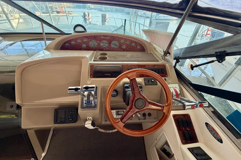 Slide: The Image of Cockpit of a 1997 Avanti 4085 Sunbridge boat with wooden steering wheel and control panel. - 8