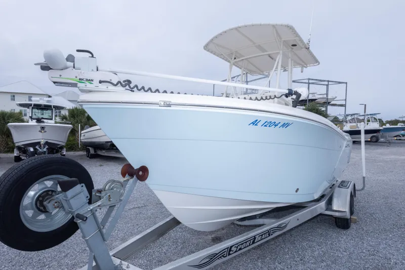 Slide: The Image of 2016 Cobia 201 Center Console boat on trailer, side view, with visible registration number. - 11