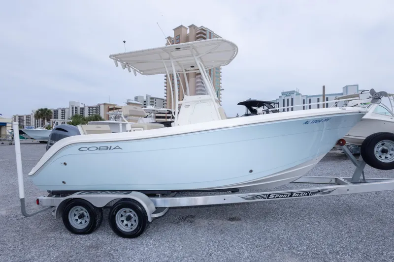 Slide: The Image of 2016 Cobia 201 Center Console boat on trailer, parked in marina lot. - 12