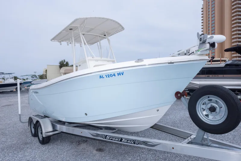 Slide: The Image of 2016 Cobia 201 Center Console boat on trailer, parked in marina lot. - 14