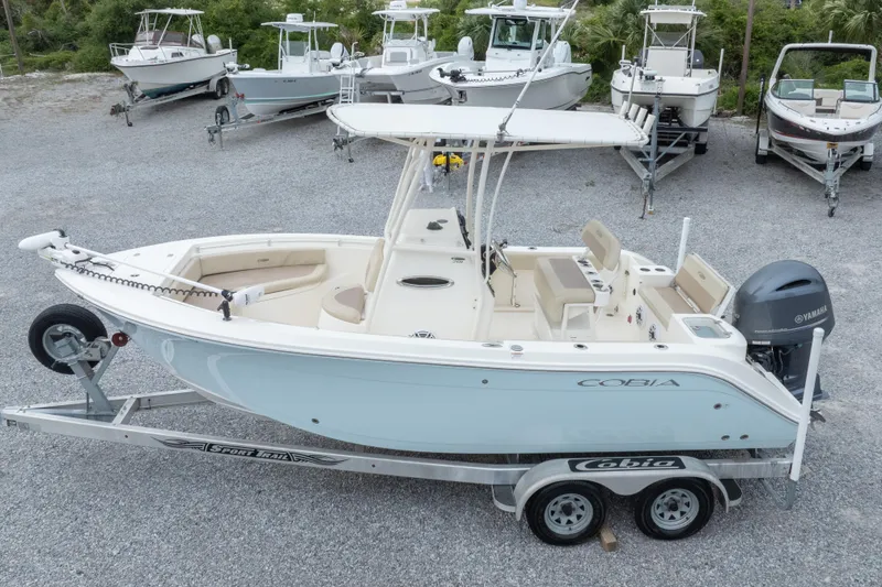 Slide: The Image of 2016 Cobia 201 Center Console boat on trailer, surrounded by other boats. - 2