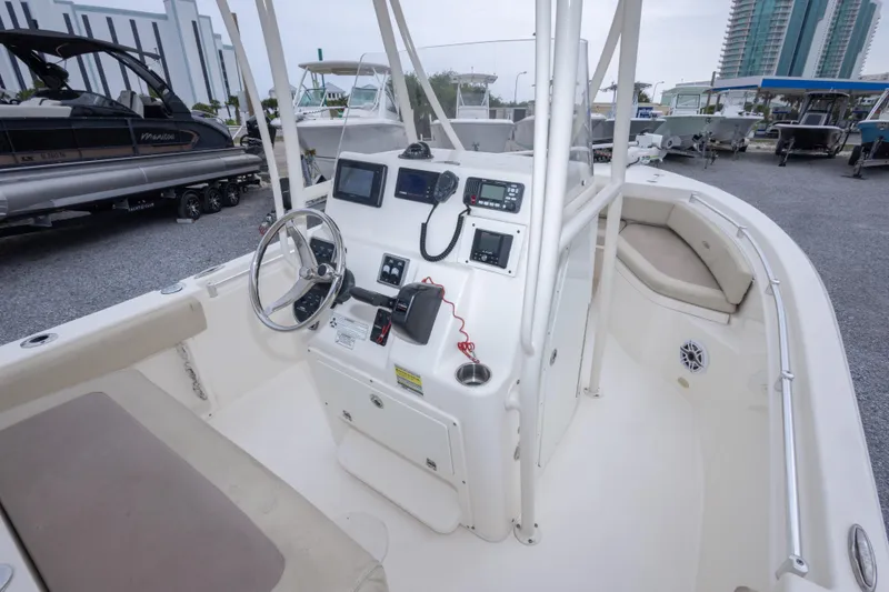 Slide: The Image of 2016 Cobia 201 Center Console boat interior with steering wheel and navigation equipment. - 24