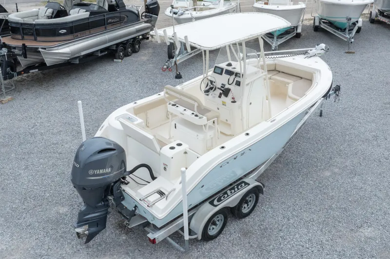 Slide: The Image of 2016 Cobia 201 Center Console boat with Yamaha engine on trailer in a marina. - 3
