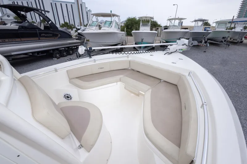 Slide: The Image of 2016 Cobia 201 Center Console boat with spacious seating, docked among other boats. - 32