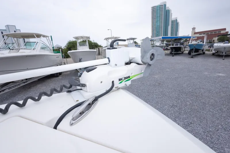 Slide: The Image of 2016 Cobia 201 Center Console with Rhodan trolling motor in a marina setting. - 35