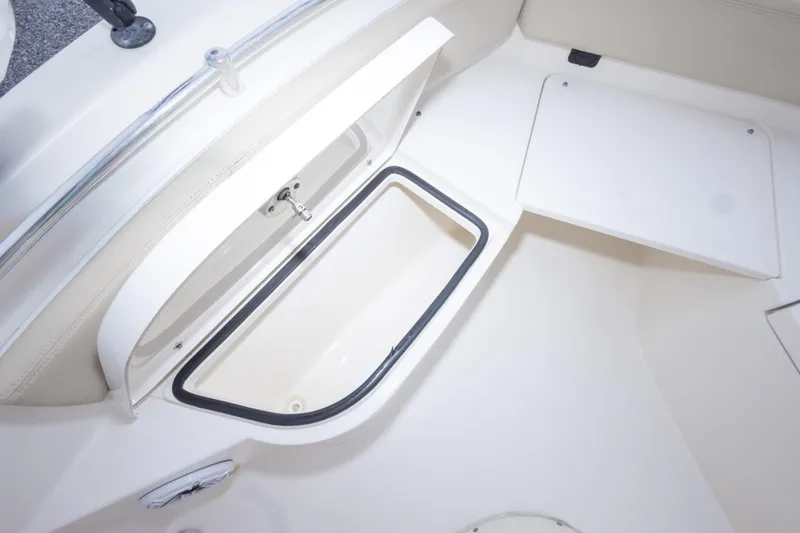 Slide: The Image of 2016 Cobia 201 Center Console boat storage compartment, open and ready for use. - 37