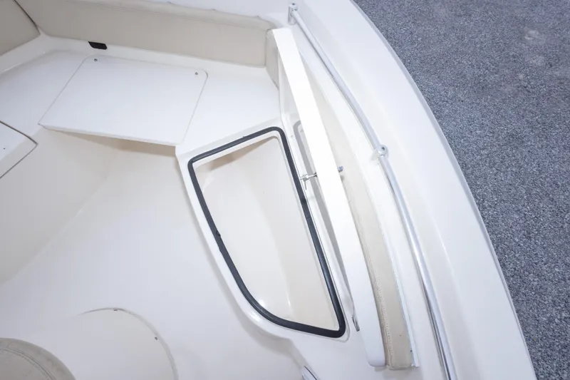 Slide: The Image of 2016 Cobia 201 Center Console boat interior with open storage compartment. - 38