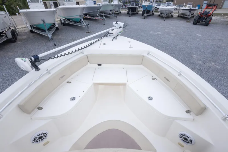 Slide: The Image of 2016 Cobia 201 Center Console boat interior with seating and storage, parked among other boats. - 39