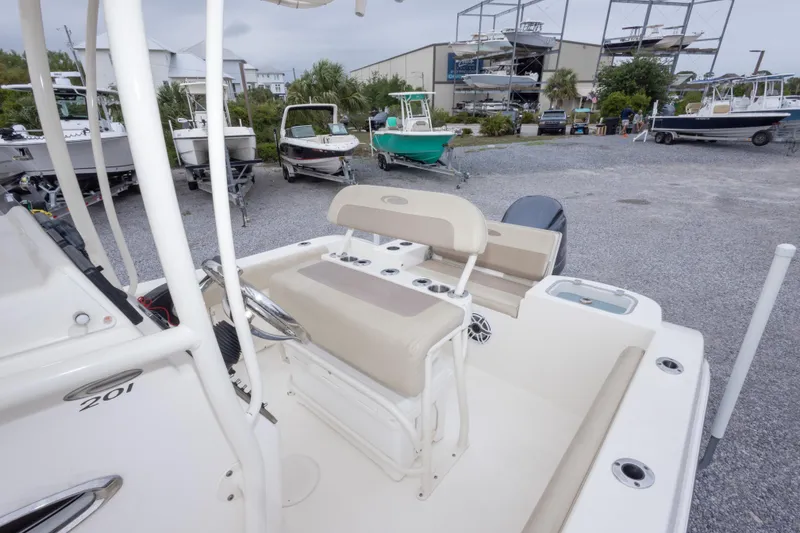 Slide: The Image of 2016 Cobia 201 Center Console boat in a marina with other vessels. - 42