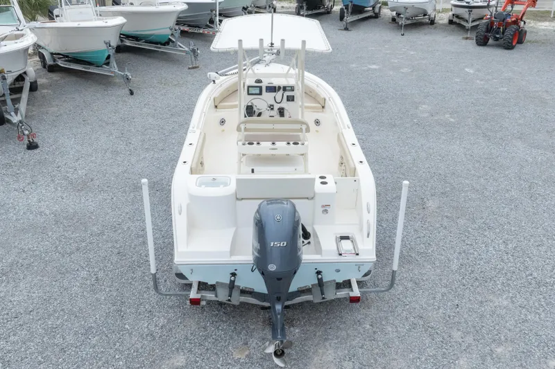 Slide: The Image of 2016 Cobia 201 Center Console boat with Yamaha 150 engine, parked on gravel. - 44