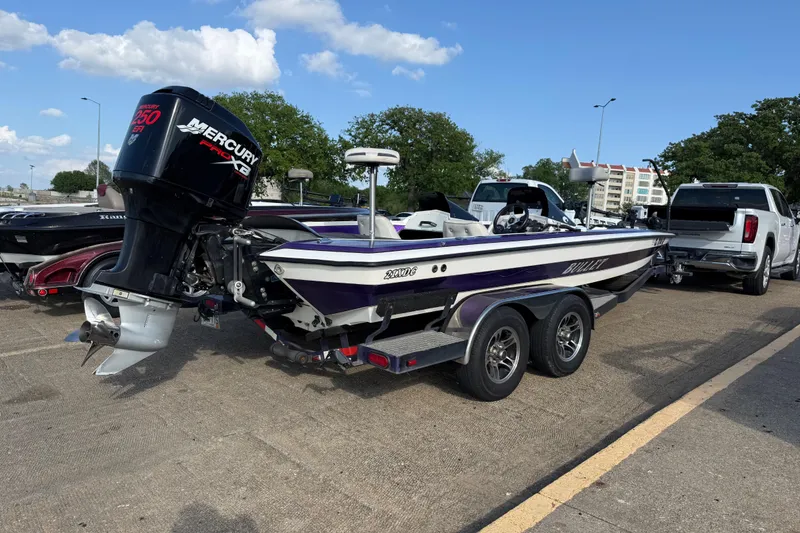 Slide: The Image of 2002 Bullet 21XDC boat with Mercury Pro XS engine on trailer in parking lot. - 10
