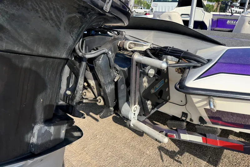 Slide: The Image of 2002 Bullet 21XDC boat engine and transom detail with purple accents. - 31