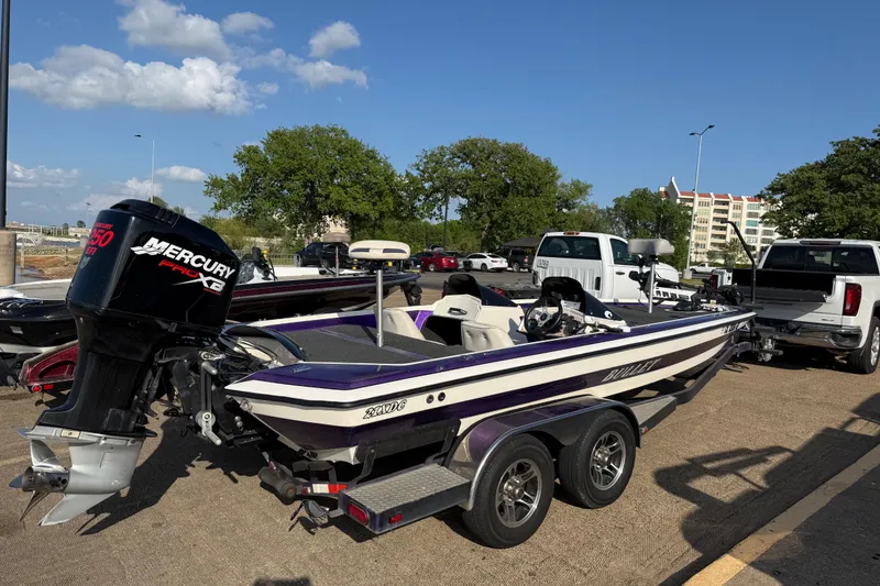 Slide: The Image of 2002 Bullet 21XDC boat with Mercury engine on trailer in parking lot. - 32