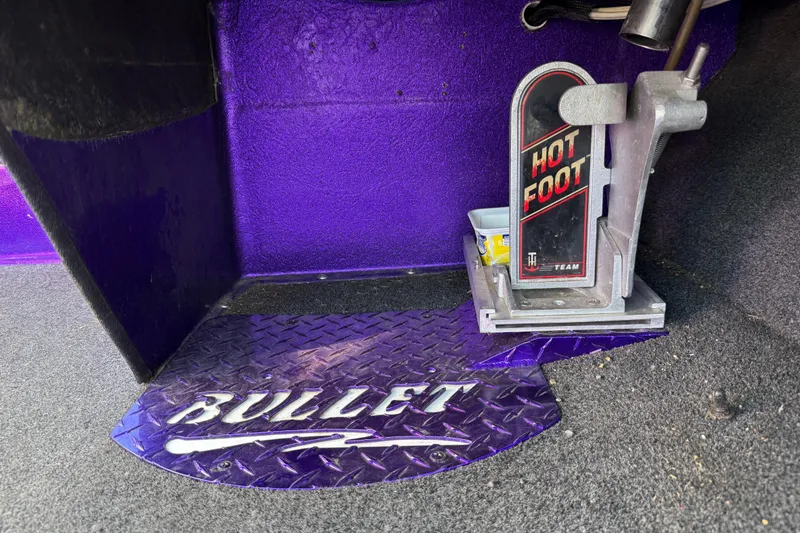 Slide: The Image of Purple interior of a 2002 Bullet 21XDC boat with "Hot Foot" pedal. - 33