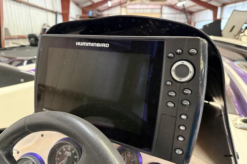 Slide: The Image of Humminbird fish finder on 2002 Bullet 21XDC boat dashboard in a garage setting. - 35