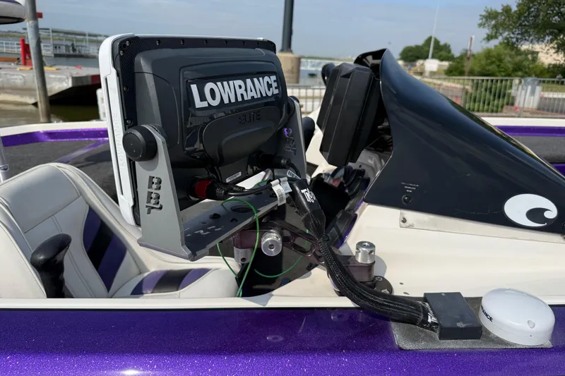 Slide: The Image of 2002 Bullet 21XDC boat with Lowrance Elite fishfinder, featuring a sleek purple and white interior. - 42