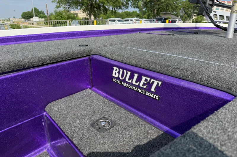 Slide: The Image of Purple and gray interior of a 2002 Bullet 21XDC performance boat. - 43