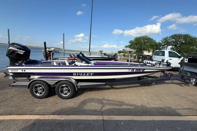 Slide: The Image of 2002 Bullet 21XDC boat with Mercury engine on trailer by lakeside. - 6
