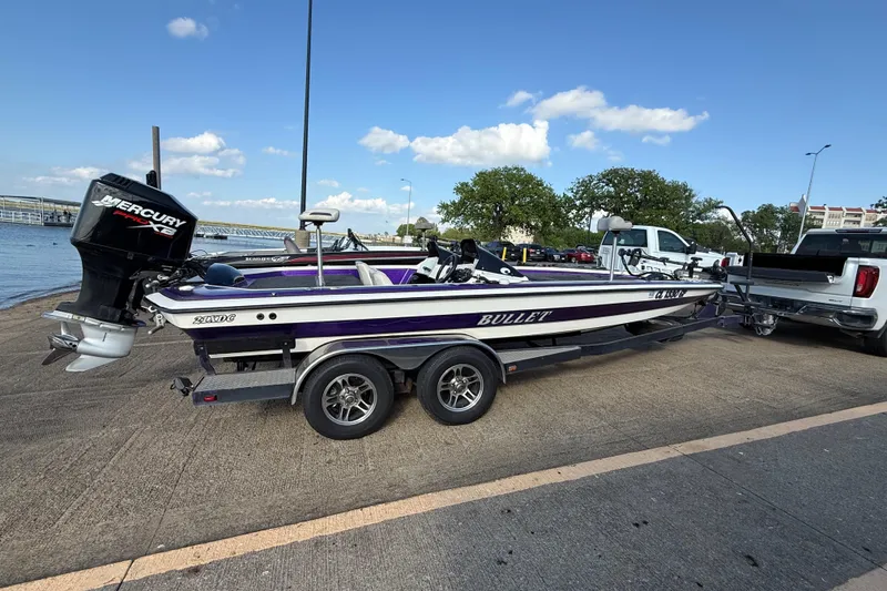 Slide: The Image of 2002 Bullet 21XDC boat with Mercury engine on trailer by waterfront. - 8