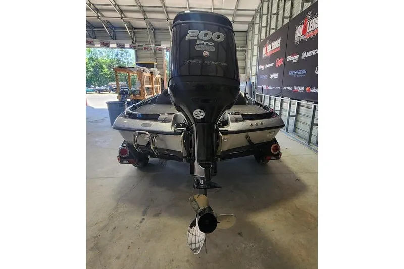 Slide: The Image of 2013 Ranger Z518 Comanche boat in a garage, rear view with 200 Pro engine. - 4