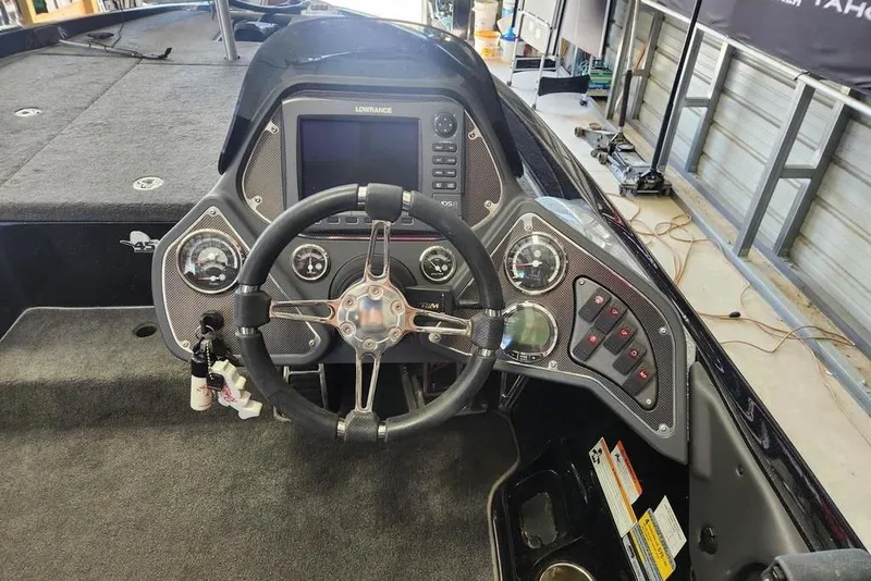 Slide: The Image of 2013 Ranger Z518 Comanche boat dashboard with steering wheel and control panel. - 7