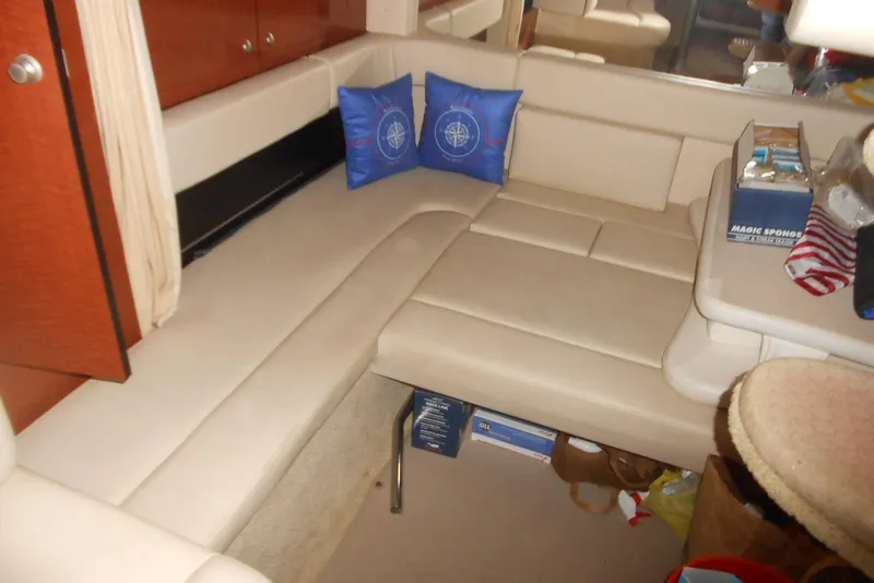 Slide: The Image of Interior of 2005 Sea Ray 340 Sundancer with beige seating and blue cushions. - 11