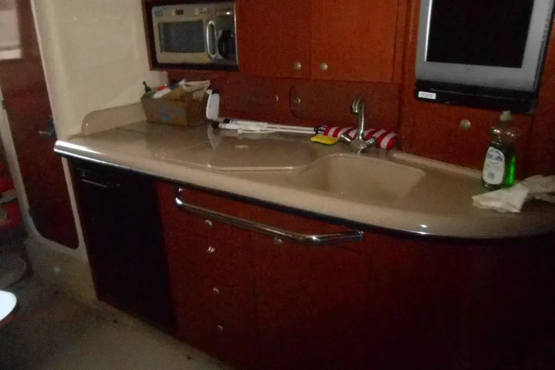 Slide: The Image of Interior galley of 2005 Sea Ray 340 Sundancer with sink, microwave, and cabinetry. - 12