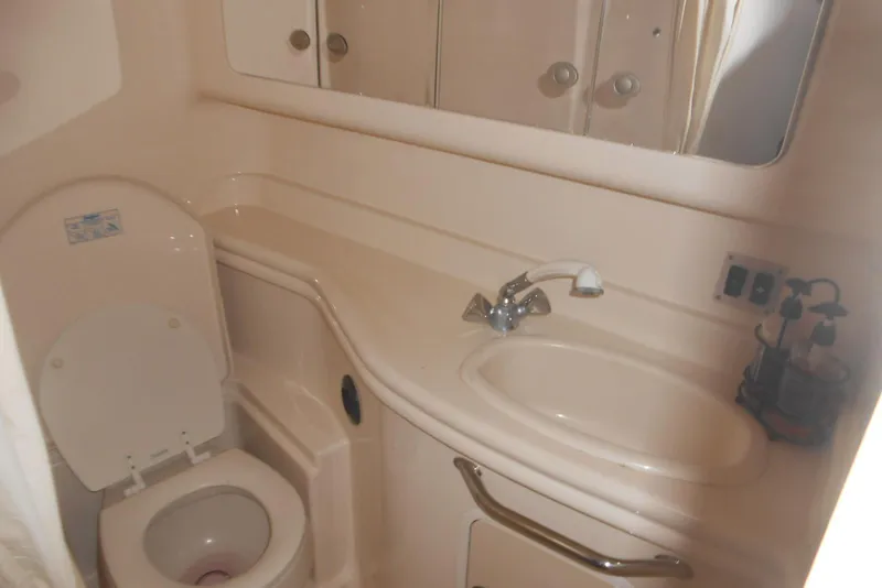 Slide: The Image of Bathroom interior of 2005 Sea Ray 340 Sundancer yacht, featuring toilet and sink. - 17