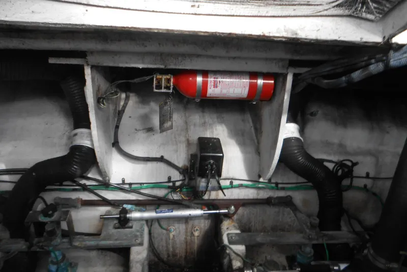 Slide: The Image of Engine compartment of a 2005 Sea Ray 340 Sundancer with fire extinguisher and hoses. - 22