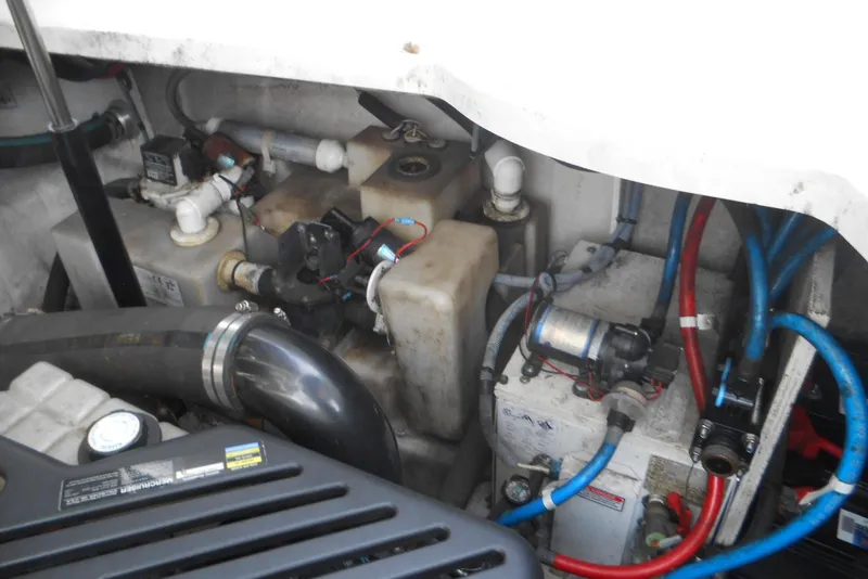 Slide: The Image of Engine compartment of a 2005 Sea Ray 340 Sundancer with visible hoses and components. - 23