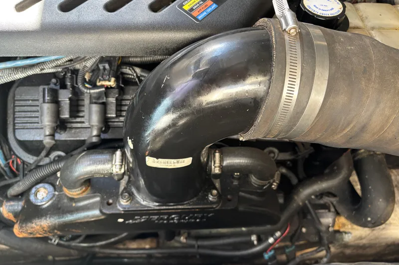 Slide: The Image of Engine components of a 2005 Sea Ray 340 Sundancer boat, featuring hoses and connectors. - 26