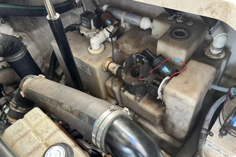Slide: The Image of Engine compartment of a 2005 Sea Ray 340 Sundancer boat, showing mechanical components and wiring. - 27