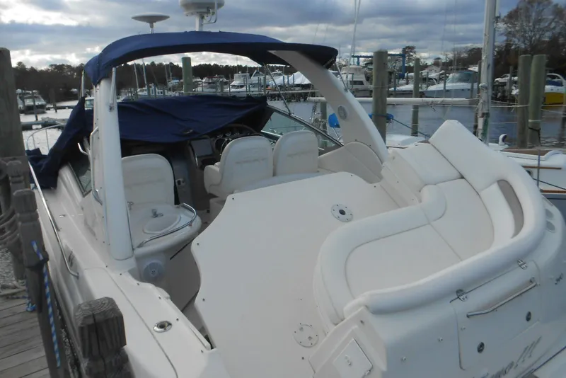 Slide: The Image of 2005 Sea Ray 340 Sundancer boat docked, featuring spacious seating and covered helm. - 3