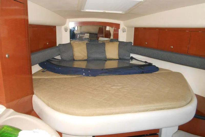 Slide: The Image of Interior cabin of 2005 Sea Ray 340 Sundancer with cozy bedding and cushions. - 8