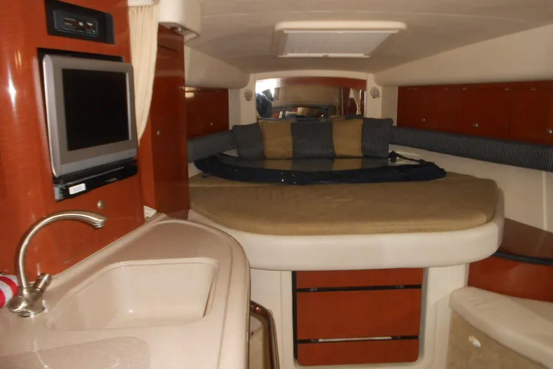 Slide: The Image of Interior of 2005 Sea Ray 340 Sundancer yacht with cozy bed and compact kitchenette. - 9