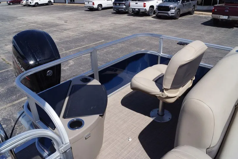 Slide: The Image of 2025 Sun Tracker Bass Buggy 18 DLX pontoon boat interior with seating and motor. - 11