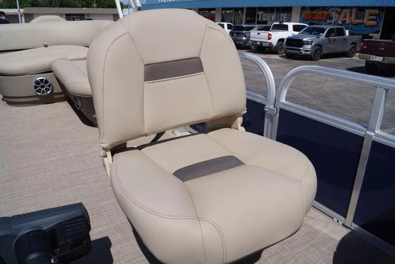 Slide: The Image of 2025 Sun Tracker Bass Buggy 18 DLX pontoon boat seat, beige upholstery, outdoor setting. - 13
