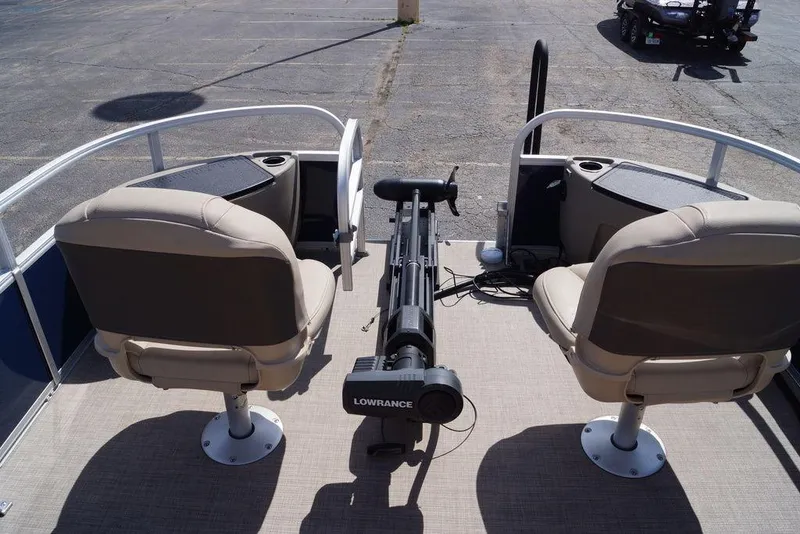 Slide: The Image of 2025 Sun Tracker Bass Buggy 18 DLX pontoon boat interior with seating and fishing equipment. - 15