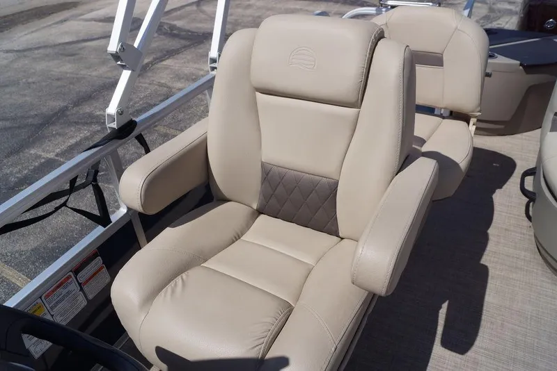 Slide: The Image of 2025 Sun Tracker Bass Buggy 18 DLX boat seat with beige upholstery and armrests. - 16