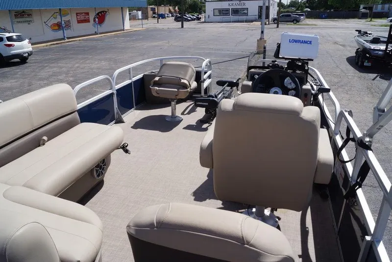 Slide: The Image of 2025 Sun Tracker Bass Buggy 18 DLX pontoon boat interior with seating and navigation equipment. - 24