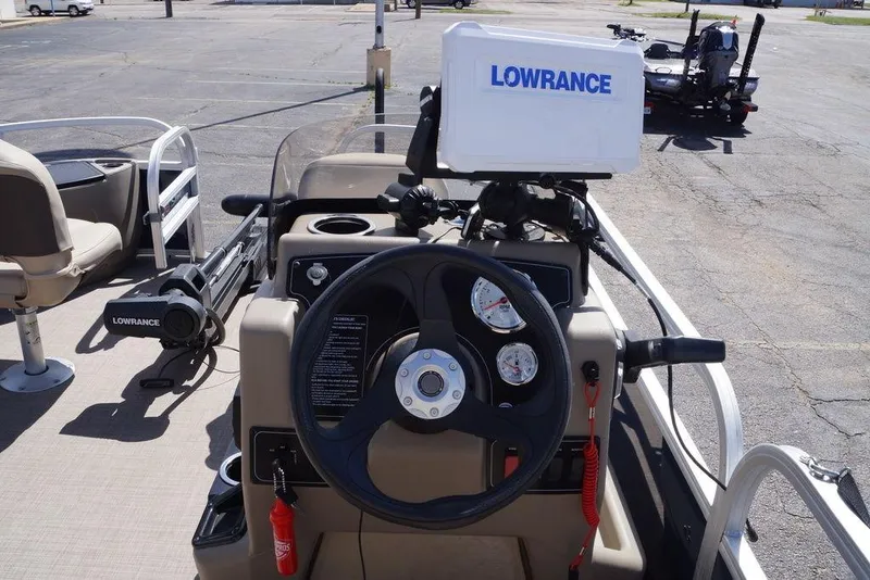 Slide: The Image of 2025 Sun Tracker Bass Buggy 18 DLX dashboard with Lowrance fish finder and steering wheel. - 9